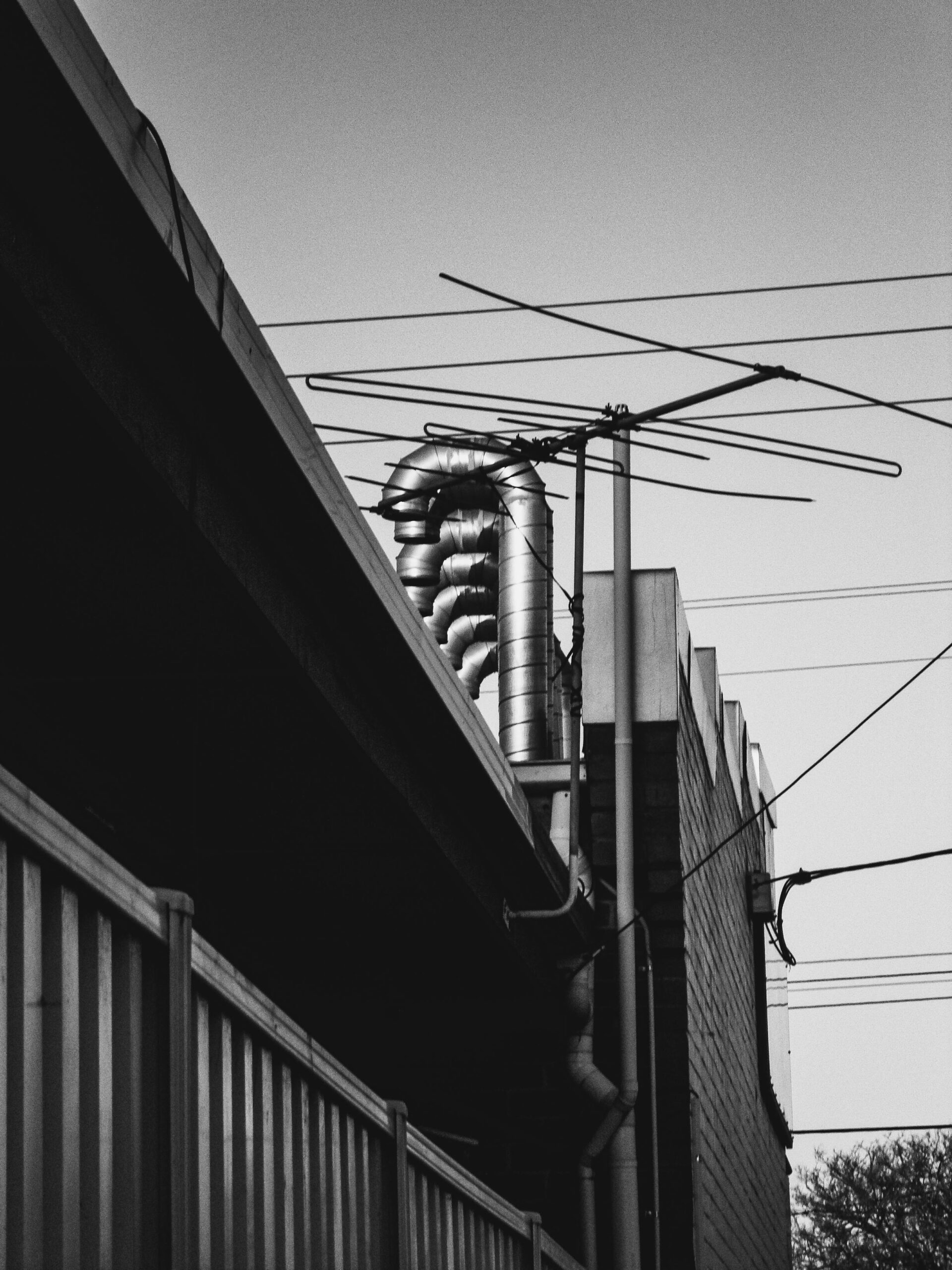 Grayscale Photo of an Antenna on a Building